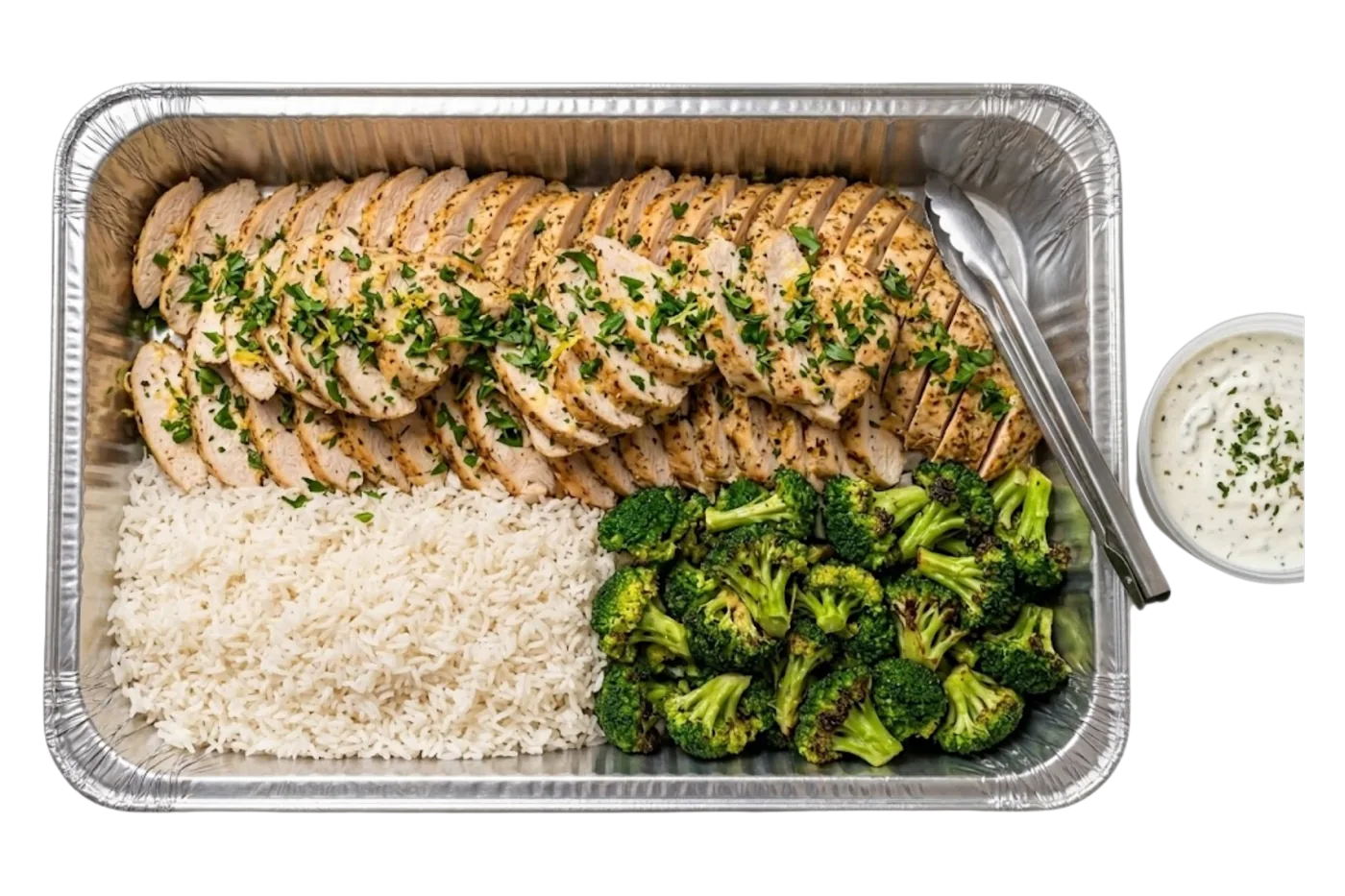 lemon honey chicken catering tray — a foil pan of herb-sliced chicken with rice and broccoli, sauce on the side, catered across the twin cities